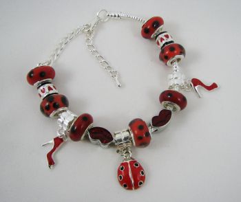 Pulsera de plata con mariquitas rojas