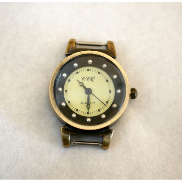 Esfera de reloj de muelle negra y bronce